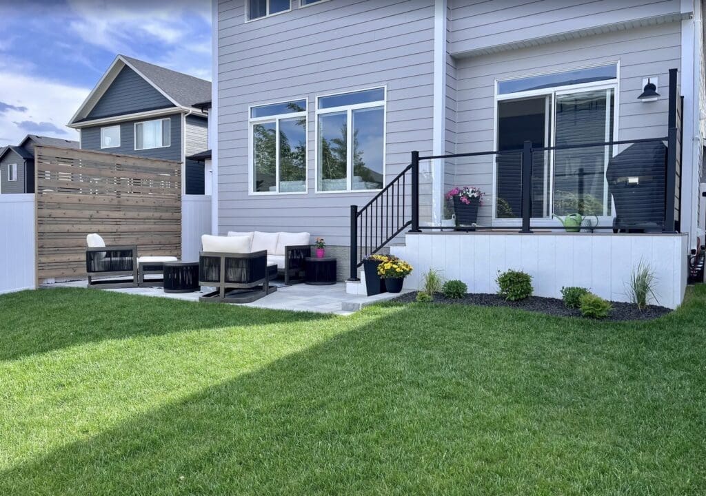 New Look Landscapes Calgary - Project Photos - New Build Home Front Yard - New sod, stone garden bed, trees and plants